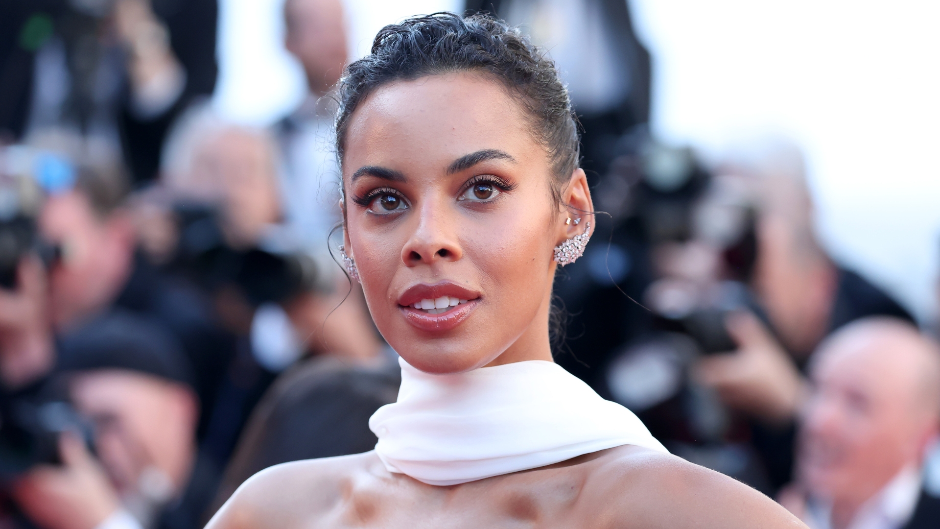 Rochelle Humes with a brunette updo, wearing a white neck scarf and strapless gown