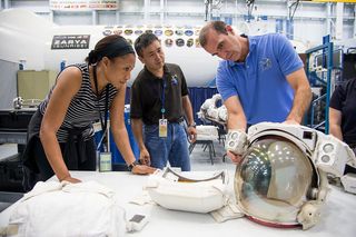 NASA astronaut Jeanette Epps, on the left, training at NASA's mock-up of the space station's airlock in 2013.