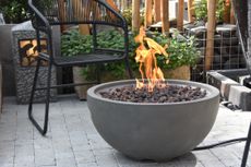 gas fire pit in a grey bowl design on a patio