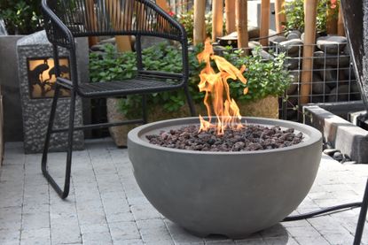 gas fire pit in a grey bowl design on a patio