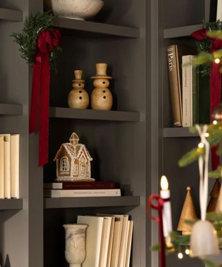 A Christmas wreath hung on a bookshelf