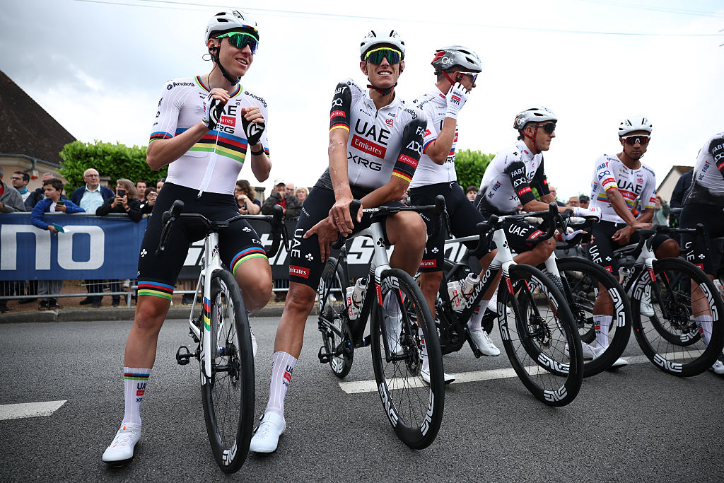 UAE Team Emirates&#039; Slovenian rider Tadej Pogacar (L) waits with teammates prior to the start of the 1st stage of the 77th edition of the Criterium du Dauphine cycling race, 195,8 km between Domérat and Montlucon, on June 8, 2025. (Photo by Anne-Christine POUJOULAT / AFP) (Photo by ANNE-CHRISTINE POUJOULAT/AFP via Getty Images)