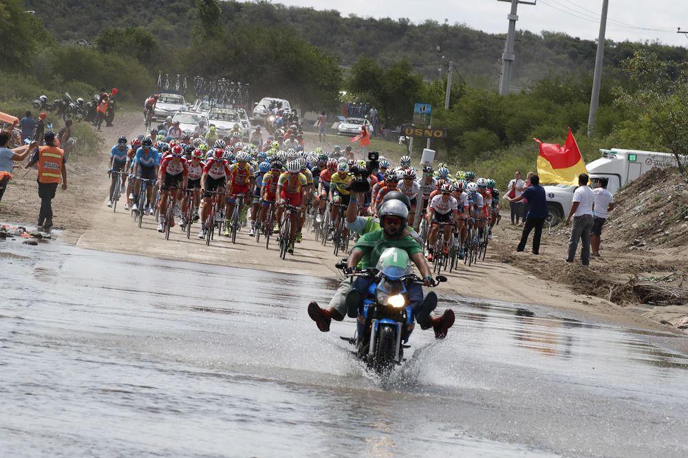 A moto official keeps his feet dry in a wash near the end of stage 4 in San Juan