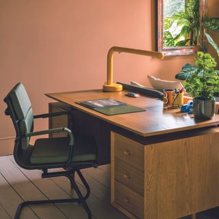 Home office with mid century modern desk and traditional office lamp.