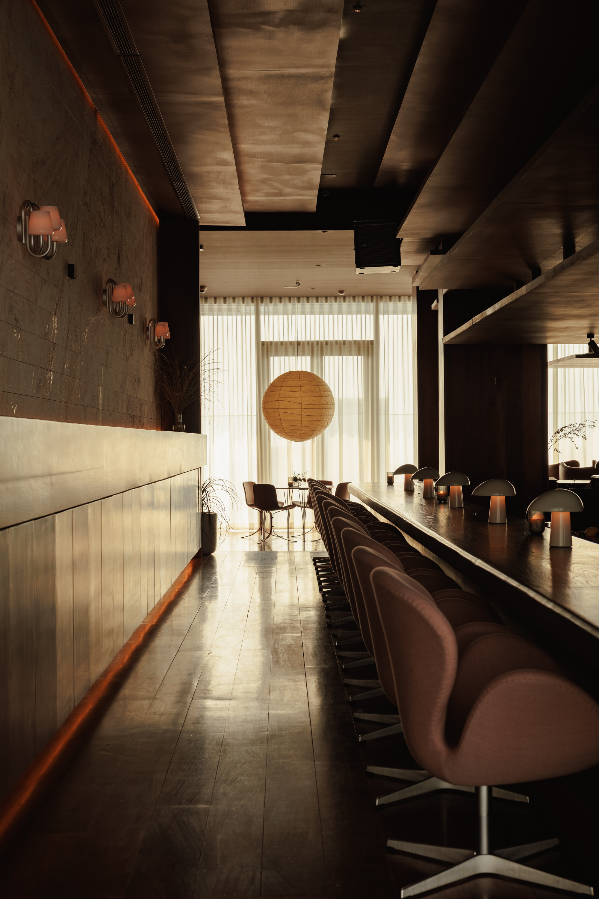 rooftop bar interior with warm wood and Fritz Hansen furniture