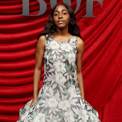 A closeup of Ayo Edebiri in a floral Loewe dress on the red carpet at the Business of Fashion BoF 500 Class of 2024 