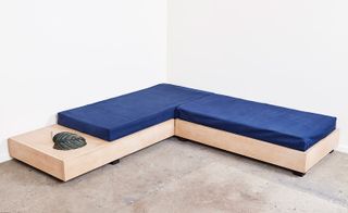 low wooden bench with navy cushions