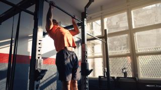 Man performs pull-ups