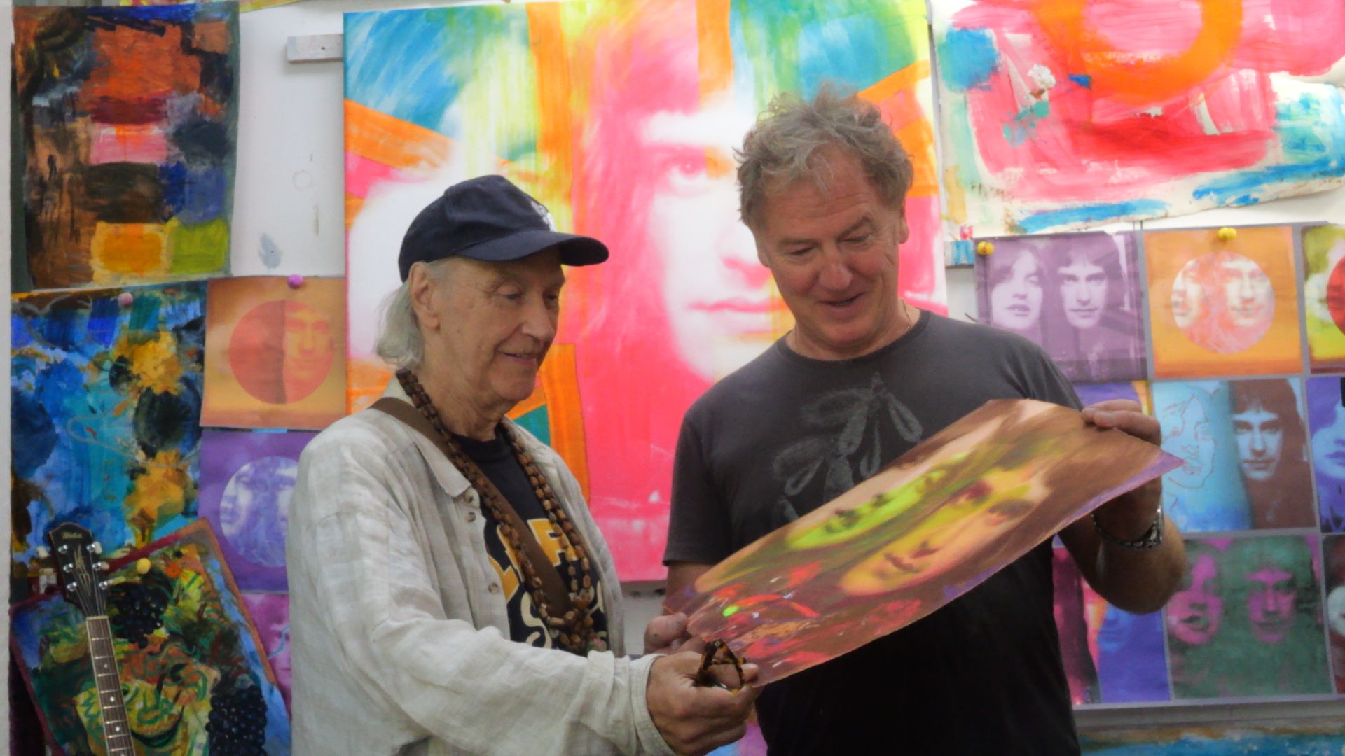 an image of Dave Davies &amp; Christian Furr holding one of the paintings in the new exhibition 