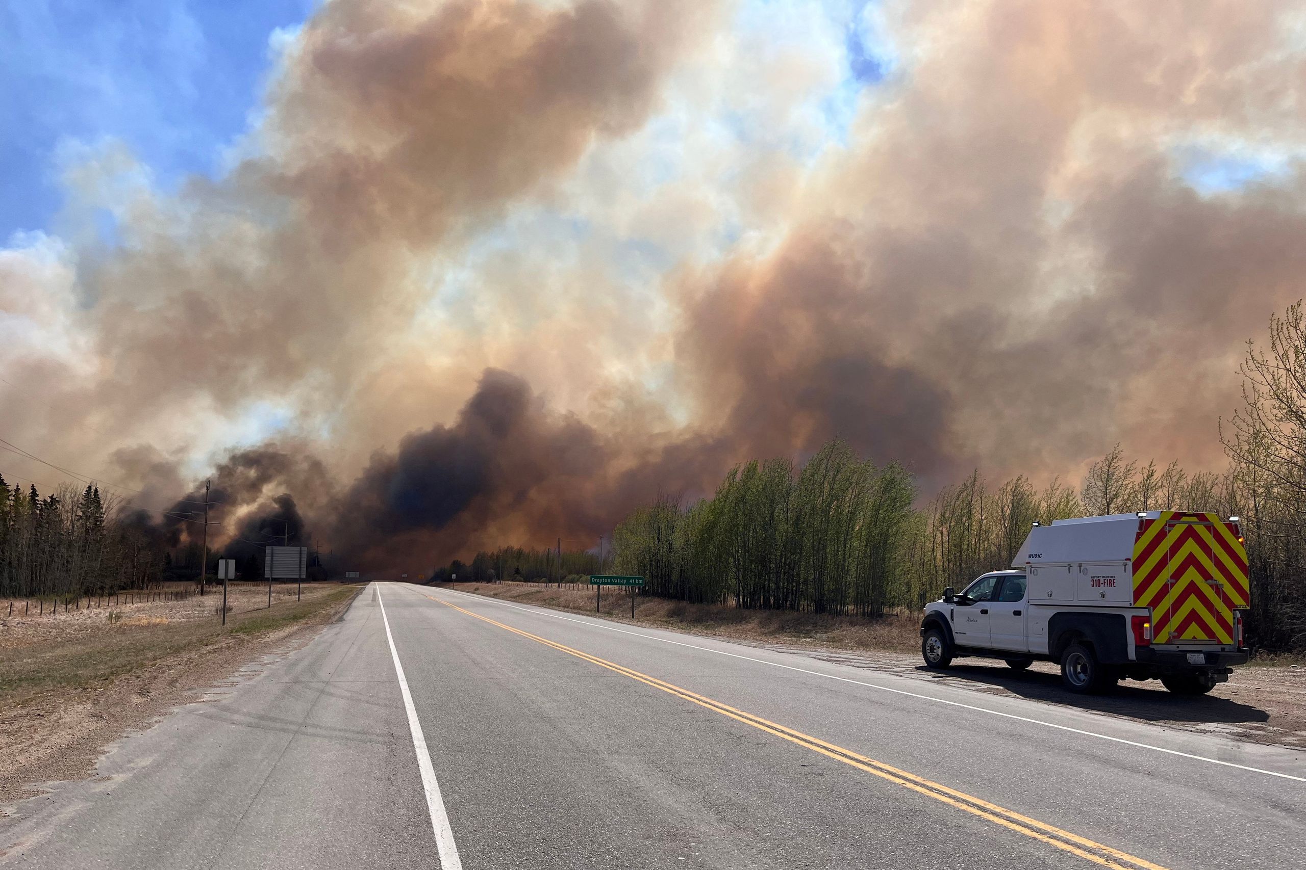 'Out of control' wildfires lead to mass evacuation in Alberta, Canada ...