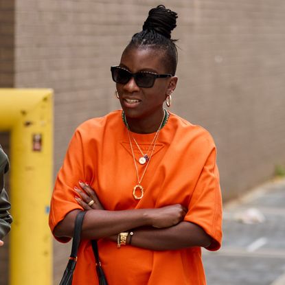 nikki ogunnaike wearing an orange dress