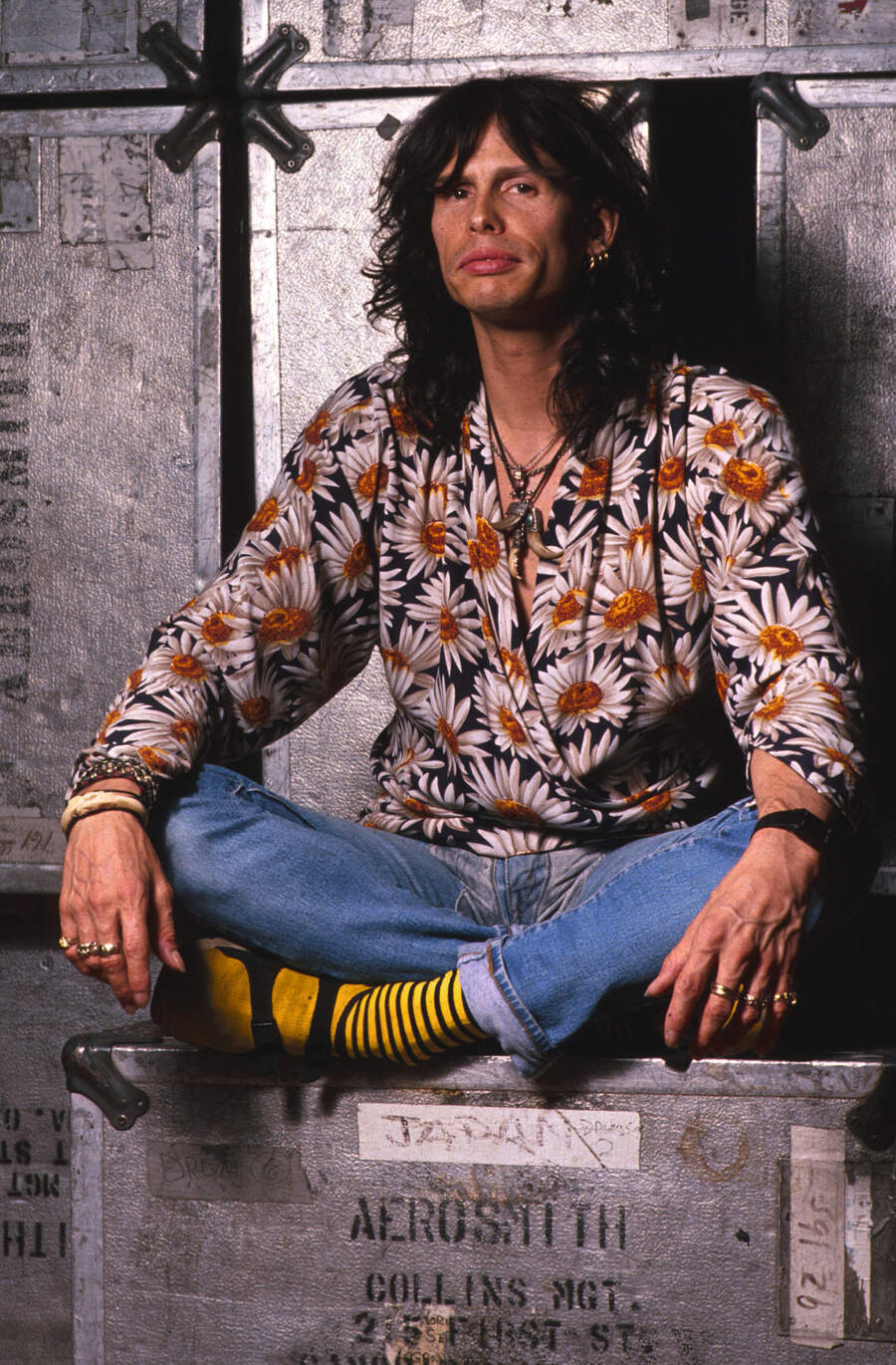 Steven Tyler sitting on an Aerosmith flightcase
