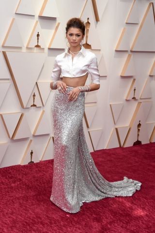 Zendaya at the 94th annual academy awards wearing a cropped white shirt and a sequin skirt