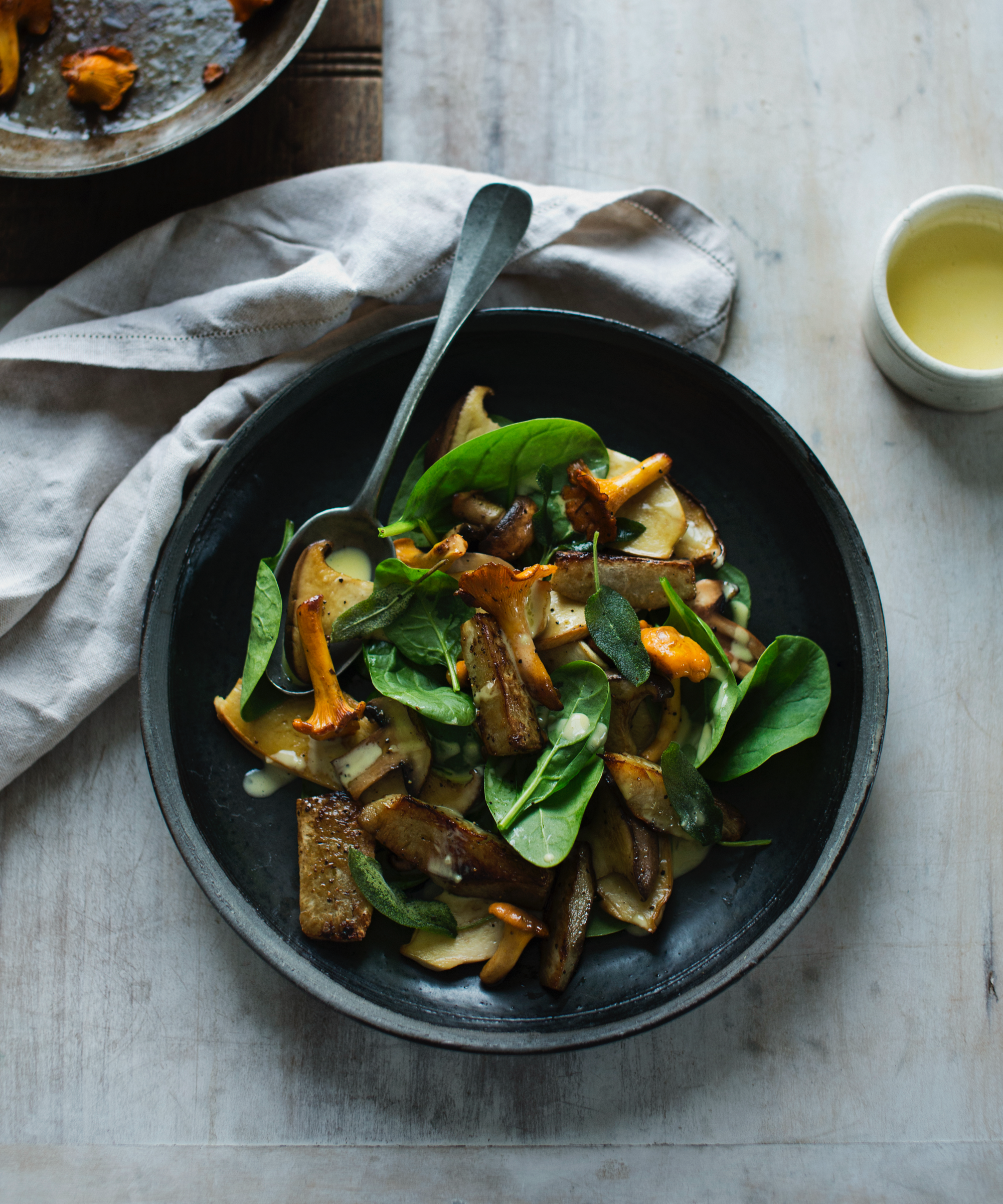 Wild mushroom stir fry on a modern black plate