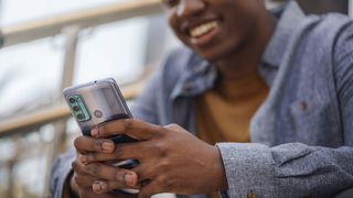 A man holds the Moto G60