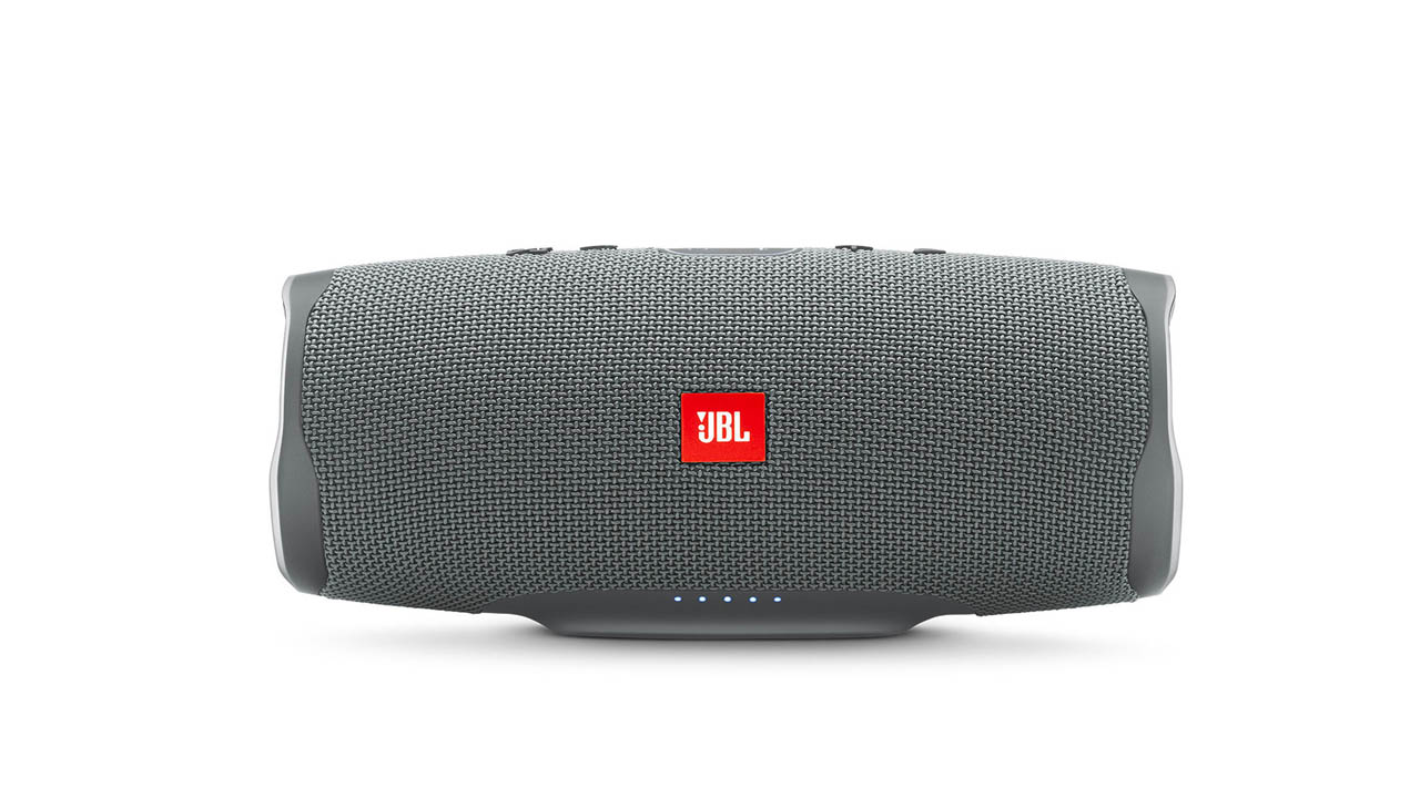 the jbl charge 4 waterproof outdoor speaker in gray with the JBL logo in red
