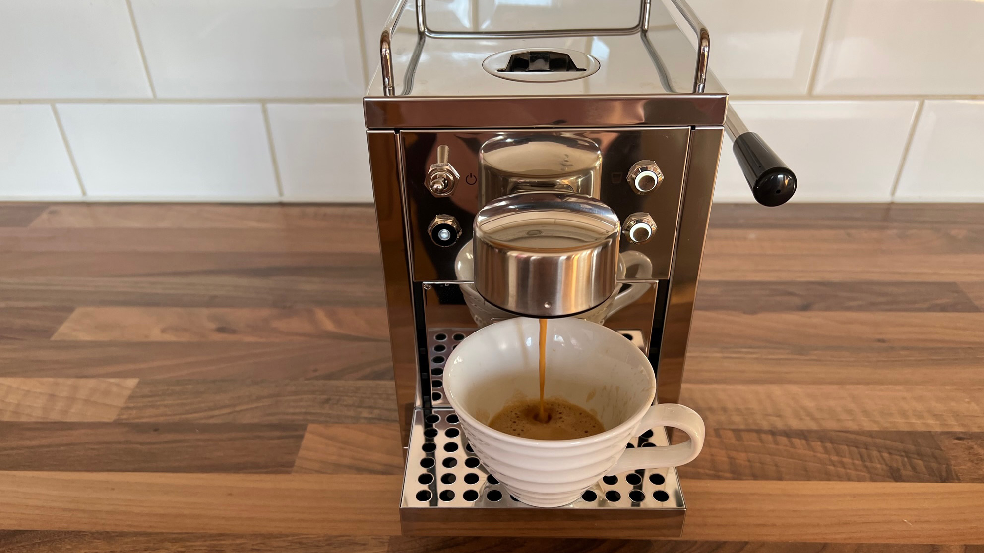 The Grind One Pod machine being used to brew an espresso