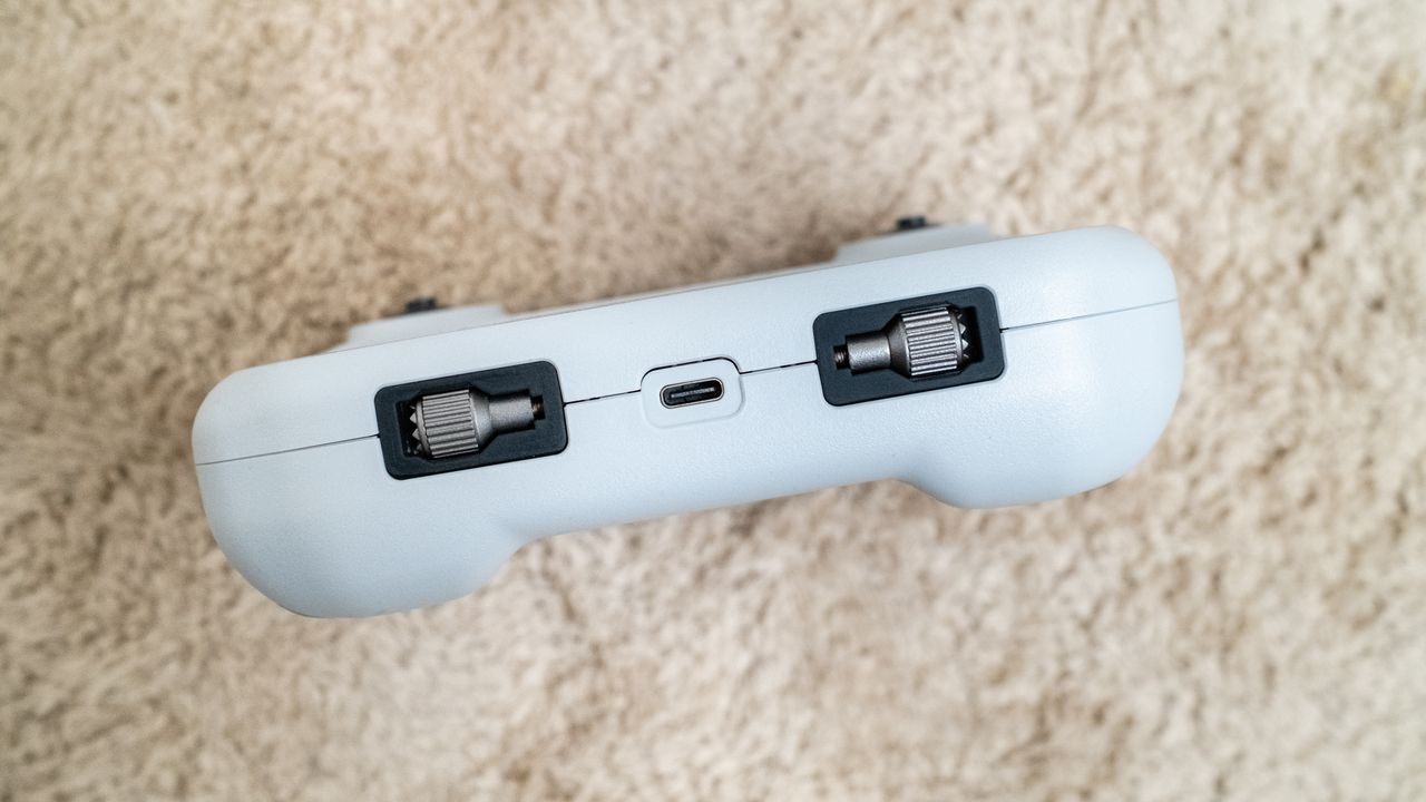 Holy Stone HS360E drone controller on a beige carpet