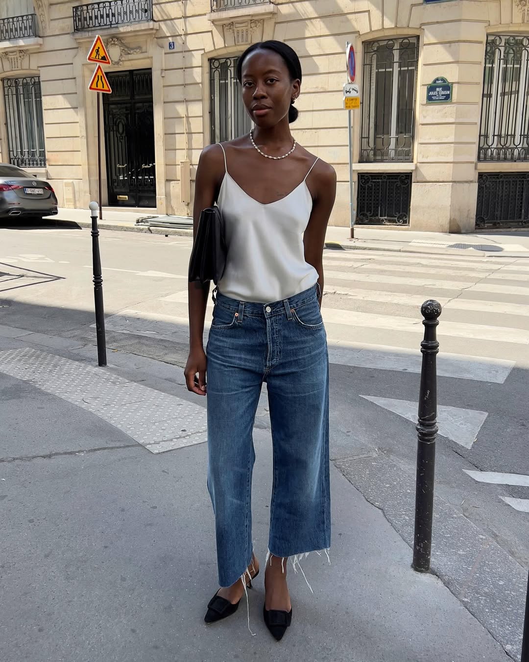 Sylvie in silk top and frayed-hem jeans