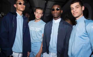 Male models wearing navy and light blue clothes from the Versace S/s 2018 collection