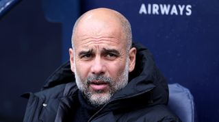 Pep Guardiola watches on during Manchester City's Premier League game against Luton in April 2024.