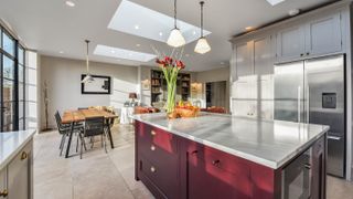red open plan kitchen with marble worktop