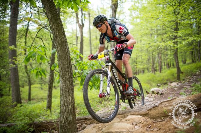 Matt Acker hits a log over during the first enduro section of stage 3