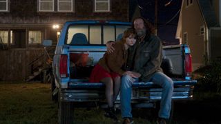Emilia Jones and Troy Kotsur sit in the bed of a pickup truck in CODA