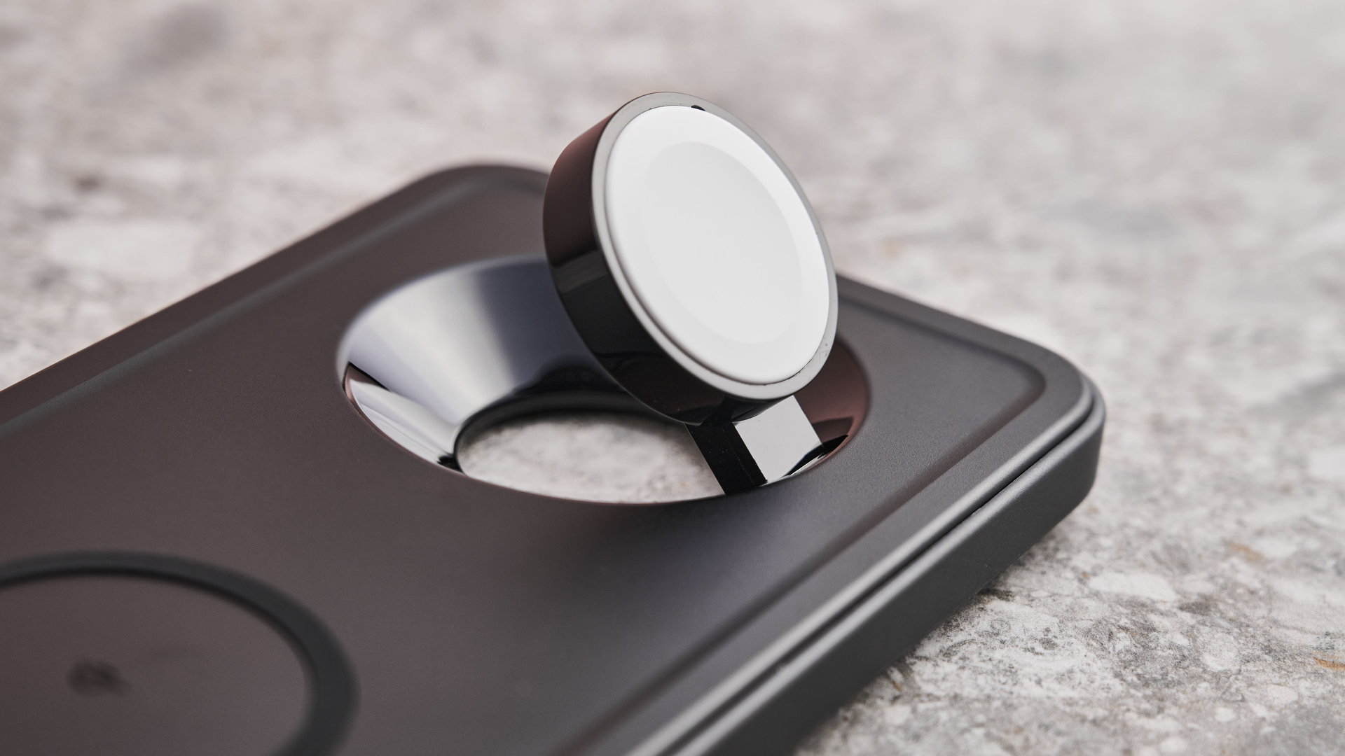 A close-up of the Apple Watch charging puck.