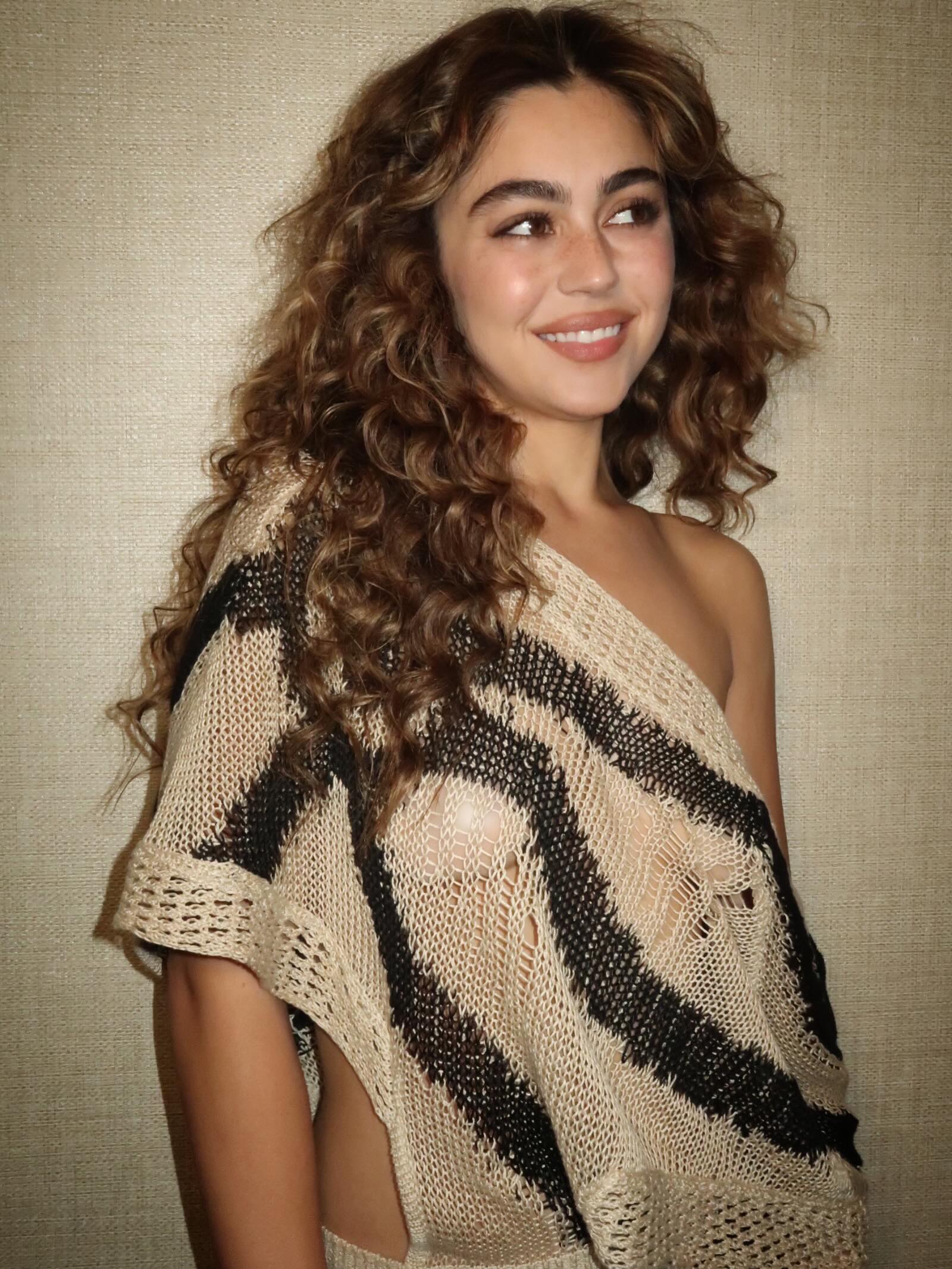 Mika Abdalla with dark hair and highlights