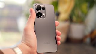 Oppo Reno 13 Pro phone in silver held in a hand