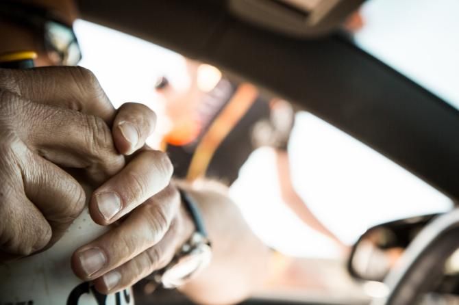 A bottle hand-off is one of the staples of professional cycling