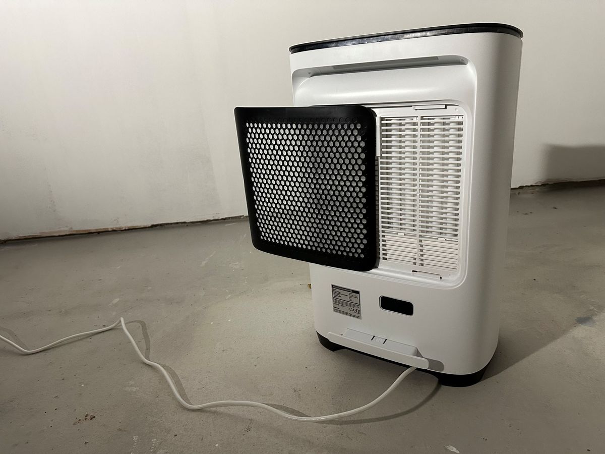 The back of a Meaco dehumidifier which has a black grate that is slightly open