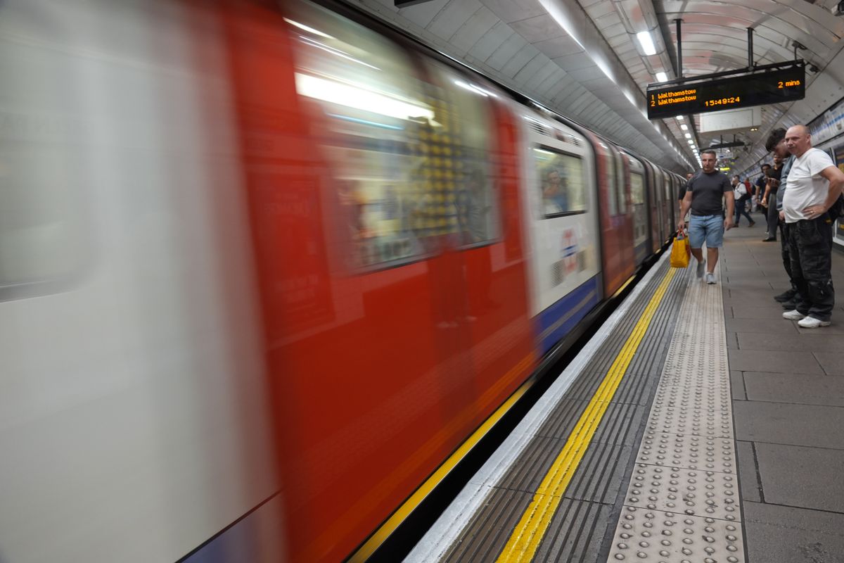 London Underground train arriving at a platform with strong motion blur.