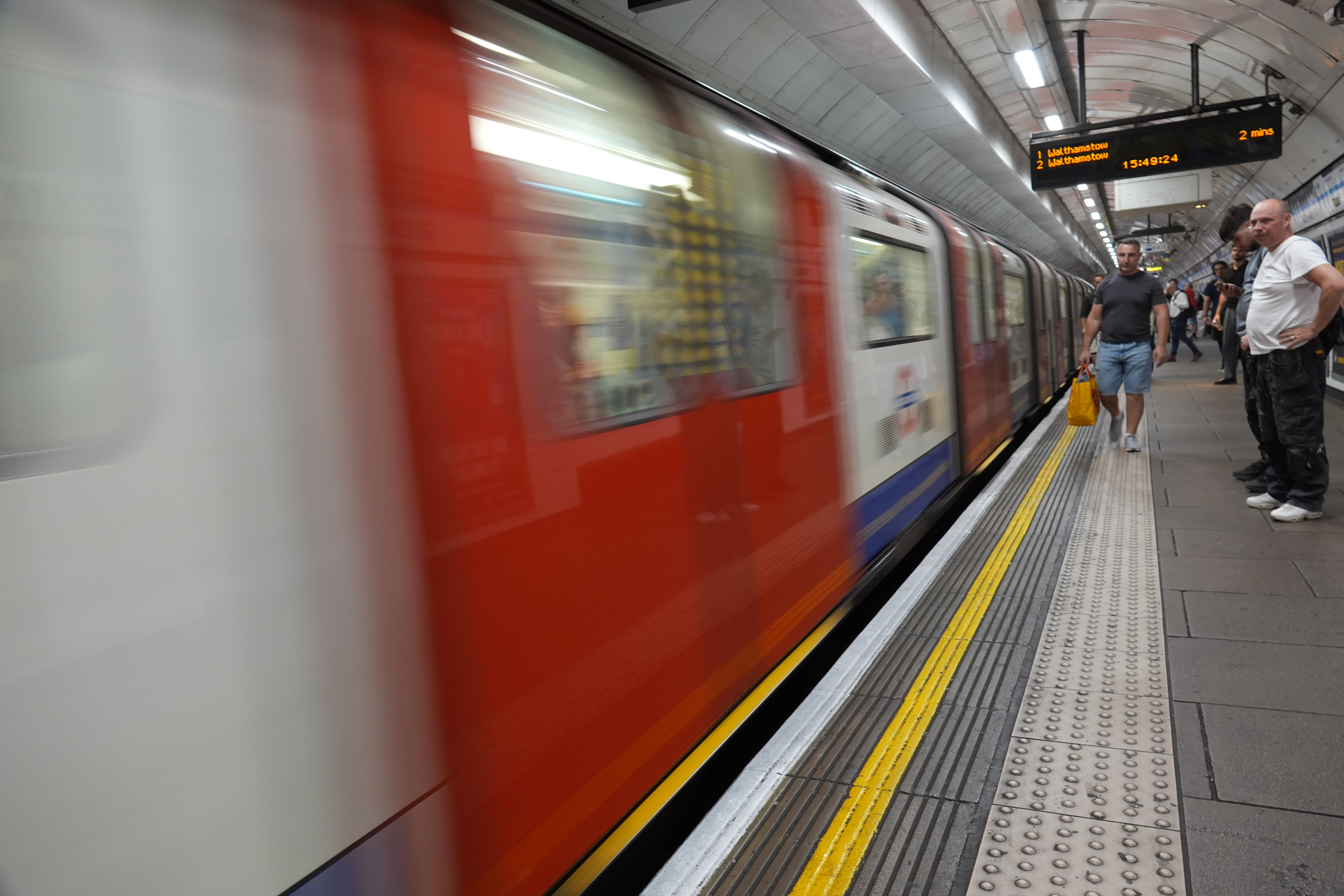 London Underground train arriving at a platform with strong motion blur.