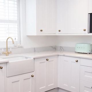 lydia bright home kitchen with wood worktops and elegant swan neck brass tap