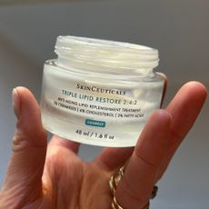 katie holding a jar of skinceuticals triple lipid restore 2:4:2 