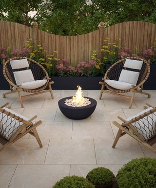 Porcelain paved patio area with firepit and chairs by Walls and Floors