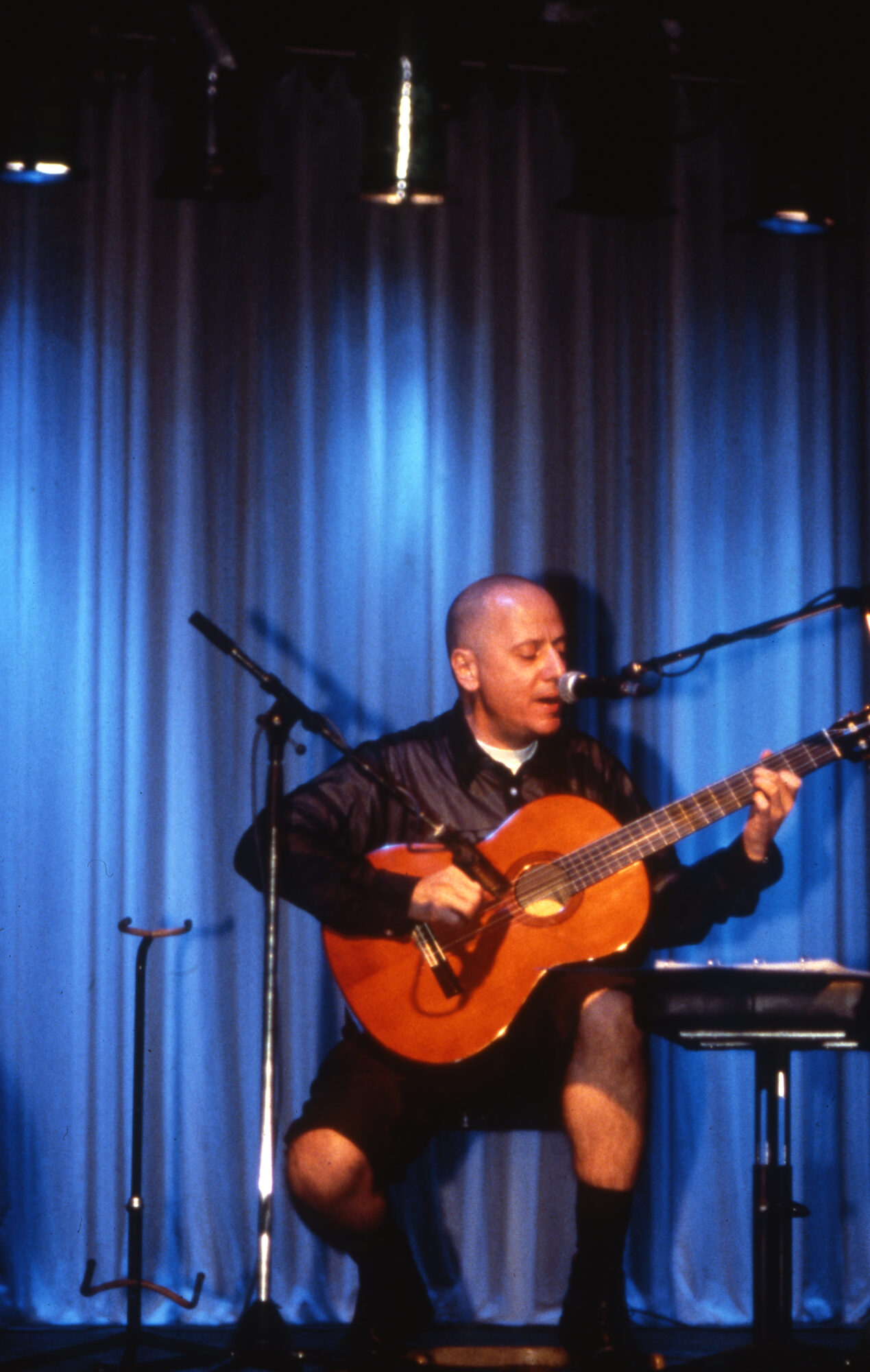 Artist playing guitar during performance