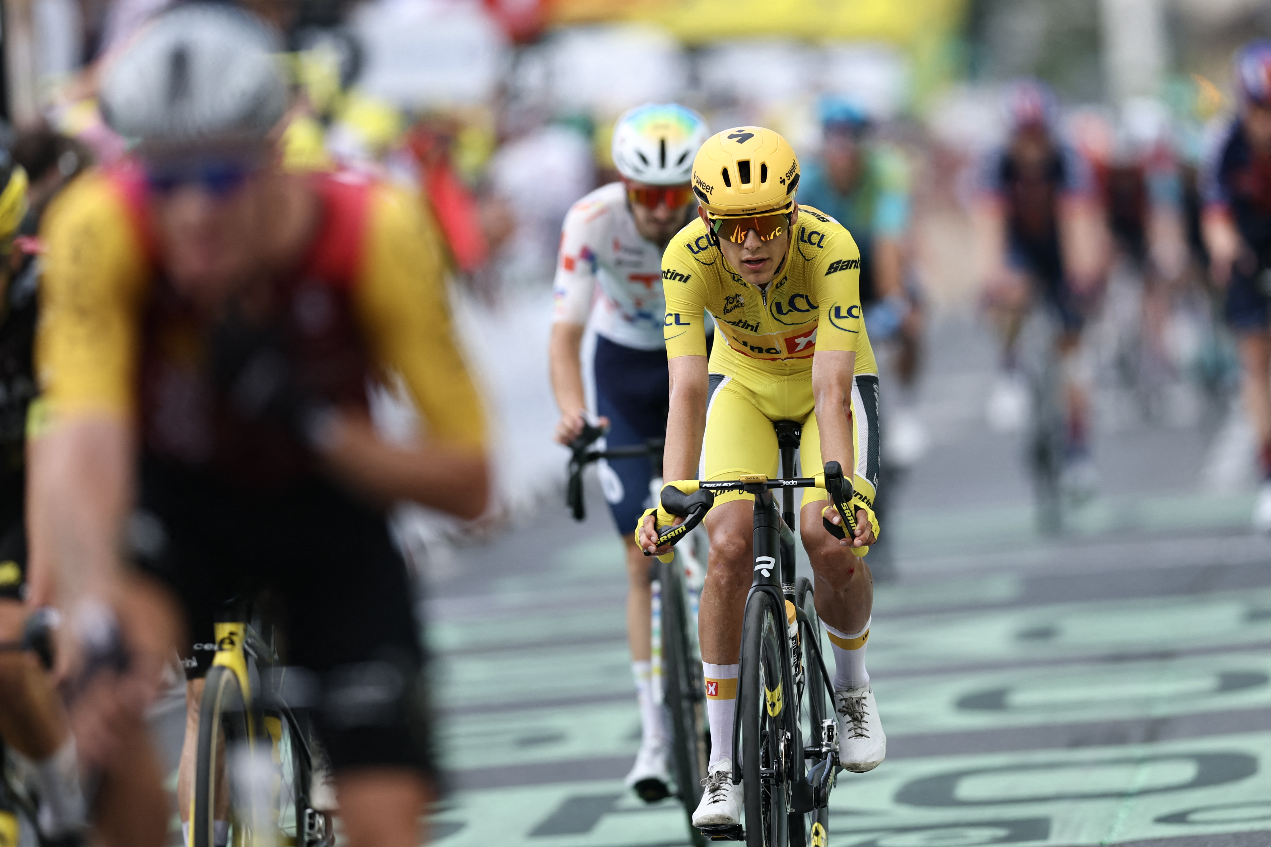 Uno-X Mobility team's Norwegian rider Torstein Traeen wearing the overall leader's yellow jersey crosses the finish line of the 5th stage of the 113th edition of the Tour de France cycling race, 158 km between Lannemezan and Pau in southwestern France, on July 8, 2026. (Photo by Anne-Christine POUJOULAT / AFP)