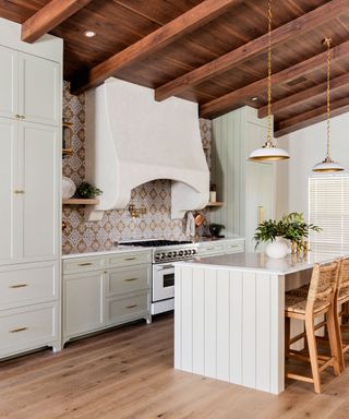 Country kitchen with cream cabinets and patterned tiled backsplash