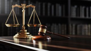 Judge's gavel on a table with scales