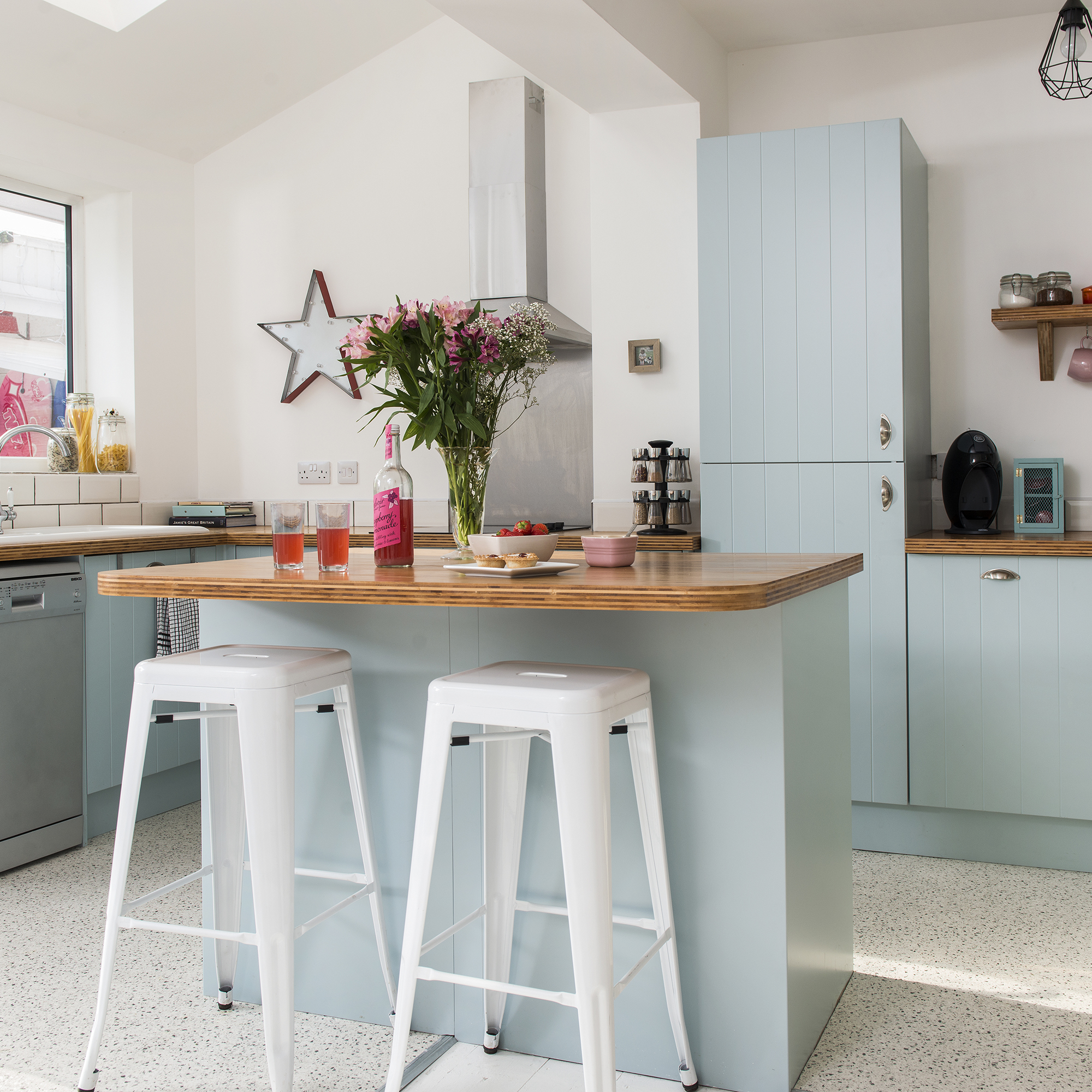 white kitchen with blue bar and stools