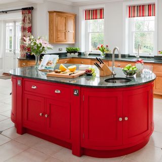 kitchen with red cabinets and worktop
