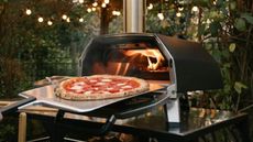 One of the best pizza ovens, the Ooni Karu 16, in an outdoor kitchen.