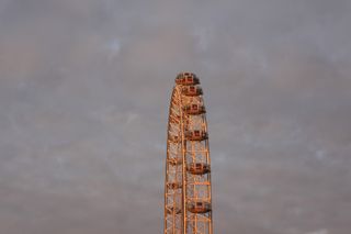 The London Eye at sunset against some dark clouds