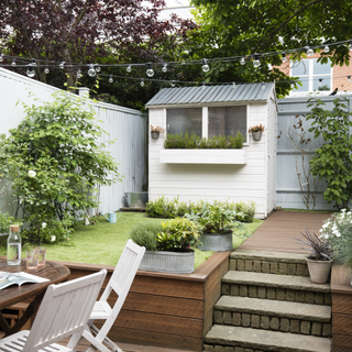 garden with white chair lighting and potted plant