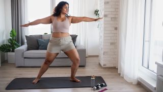 Should you work out every day? Image shows woman doing yoga
