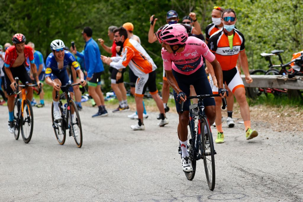 Overall leader Team Ineos rider Colombias Egan Bernal R check Team Bahrain rider Italys Damiano Caruso Rear L and Team Deceuninck rider Portugals Joao Almeida as they ride in the final ascent during the 19th stage of the Giro dItalia 2021 cycling race 166km between Abbiategrasso and Alpe di Mera on May 28 2021 Photo by Luca Bettini POOL AFP Photo by LUCA BETTINIPOOLAFP via Getty Images