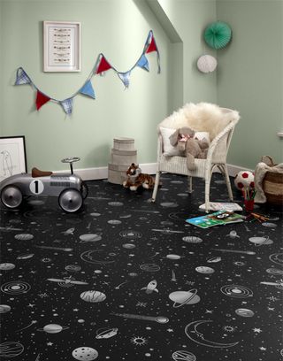 A black and white galaxy design floor in a children's playroom